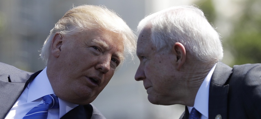 President Donald Trump talks with Attorney General Jeff Sessions, gestures before speaking at the 36th Annual National Peace Officers' memorial service, Monday, May 15. 2017, on Capitol Hill in Washington.