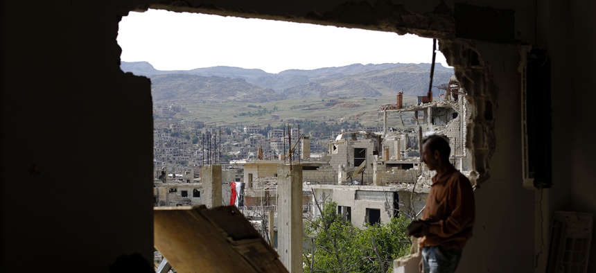 A man checks the damage at the mountain resort town of Zabadani in the Damascus countryside, Syria, Thursday, May 18, 2017.