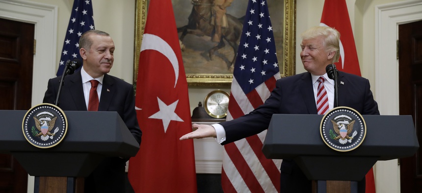 President Donald Trump reaches to shake hands with Turkish President Recep Tayyip Erdogan in the Roosevelt Room of the White House in Washington, Tuesday, May 16, 2017.