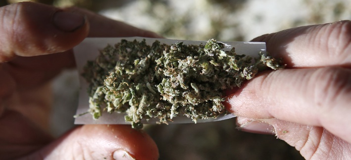 Medical marijuana for a veteran U.S. Marine is rolled into a joint in Belfast, Maine, Nov. 21, 2014.