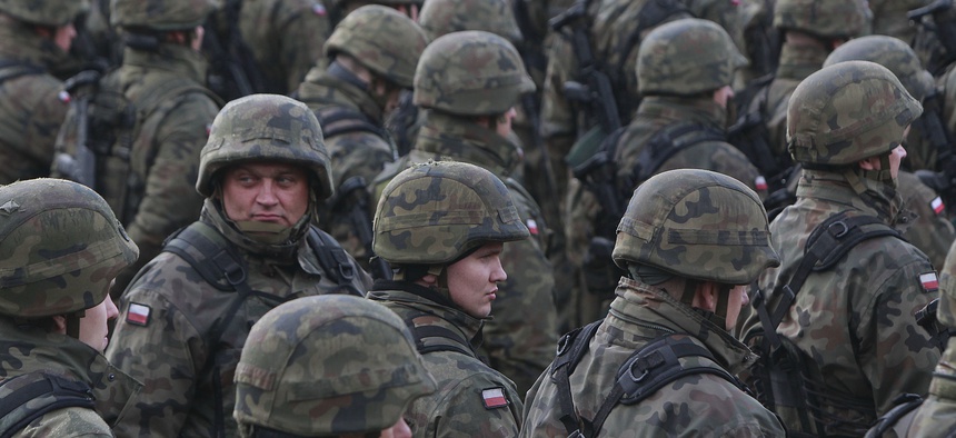 Polish soldiers attend a welcoming ceremony for U.S.-led NATO troops at polygon in Orzysz, northeastern Poland, Thursday, April 13, 2017.
