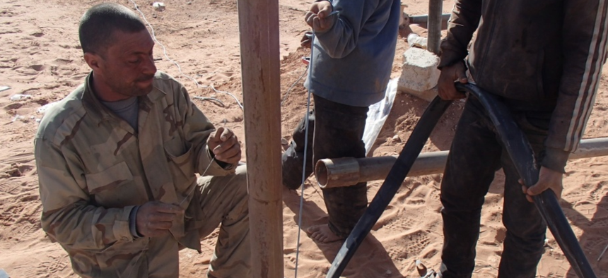 Members of Maghawir al-Thawra work to repair a water well in At Tanf Garrison in southern Syria for partner forces fighting ISIS and locals in the area.