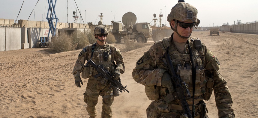 U.S. Army soldiers move through Qayara West Coalition base in Qayara, some 50 kilometers south of Mosul, Iraq.