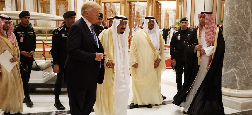 President Donald Trump and Saudi King Salman, center left, arrive to the Arab Islamic American Summit, at the King Abdulaziz Conference Center, Sunday, May 21, 2017, in Riyadh, Saudi Arabia.