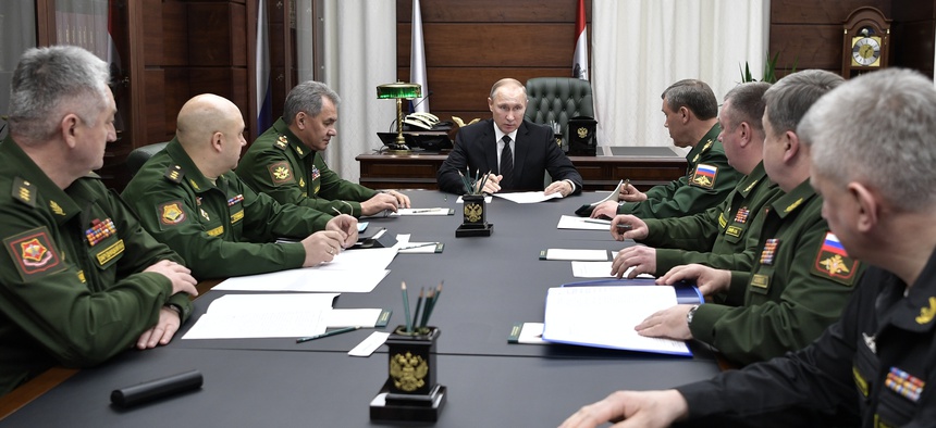 Russian President Vladimir Putin, center, meets with senior military officials in Moscow last year.