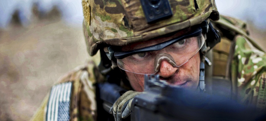 Karkh Area Command Strike Team soldiers rush onto a simulated battlefield during a joint air assault demonstration on Camp Taji, Iraq, March 29, 2010