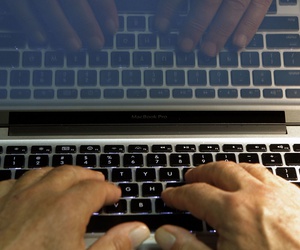 In this Feb. 27, 2013, file photo illustration, hands type on a computer keyboard in Los Angeles. In this Feb. 27, 2013, file photo illustration, hands type on a computer keyboard in Los Angeles.