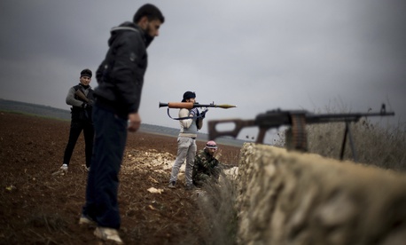 Free Syrian Army fighters take their positions, close to a military base, near Azaz, Syria, Dec. 10, 2012. Free Syrian Army fighters take their positions, close to a military base, near Azaz, Syria, Dec. 10, 2012.