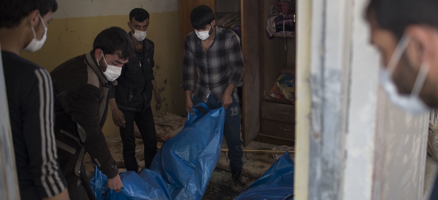 Rsidents carry the body of a person killed in an airstrike during fighting between Iraq security forces and Islamic State on the western side of Mosul, Iraq in March.