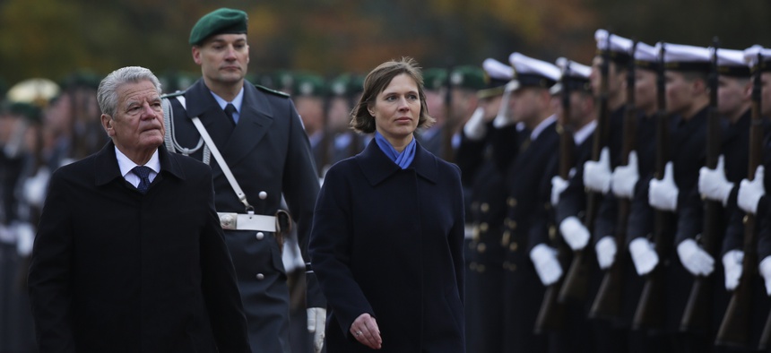 German President Joachim Gauck, left, and Estonia's President Kersti Kaljulaid, right, review the honor guard prior to a meeting at Bellevue Palace in Berlin, Friday, Nov. 11, 2016.