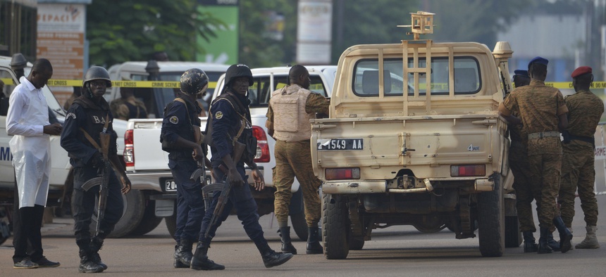 Security forces stand guard outside the site of a restaurant attacked in Ouagadougou, Burkina Faso, Monday, Aug. 14 , 2017. The death toll is still rising.