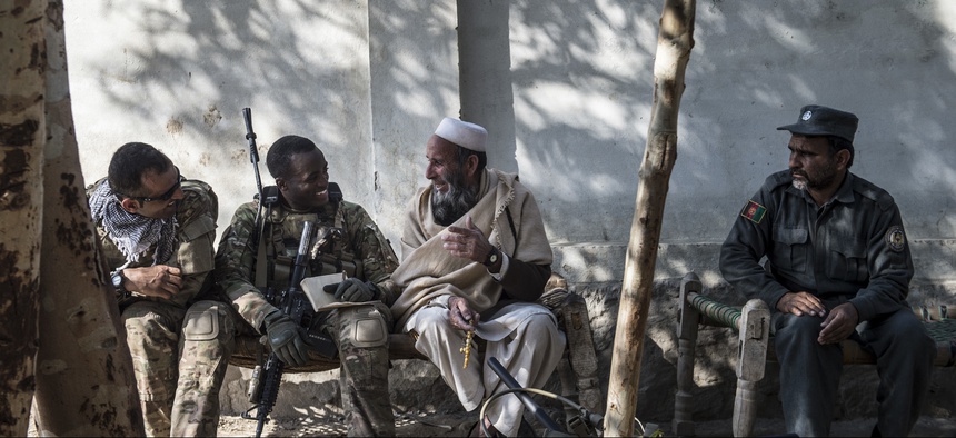 A U.S. Army soldier talks with an Afghan village elder during a key leader engagement outside of Camp Fenty, Afghanistan, Feb. 18, 2016.