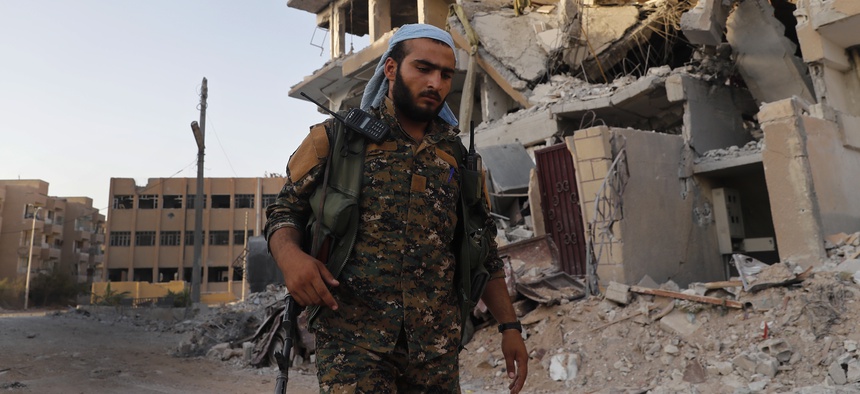 A U.S.-backed Syrian Democratic Forces fighter on the front line in Raqqa, northeast Syria, Thurs., July 27, 2017.