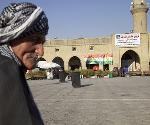 Saber Salim sits outside Irbil's Citadel near a campaign poster urging people to vote 'yes' in September's schedule referendum on independence from Iraq, Aug. 24, 2017. Saber Salim sits outside Irbil's Citadel near a campaign poster urging people to vote 'yes' in September's schedule referendum on independence from Iraq, Aug. 24, 2017.