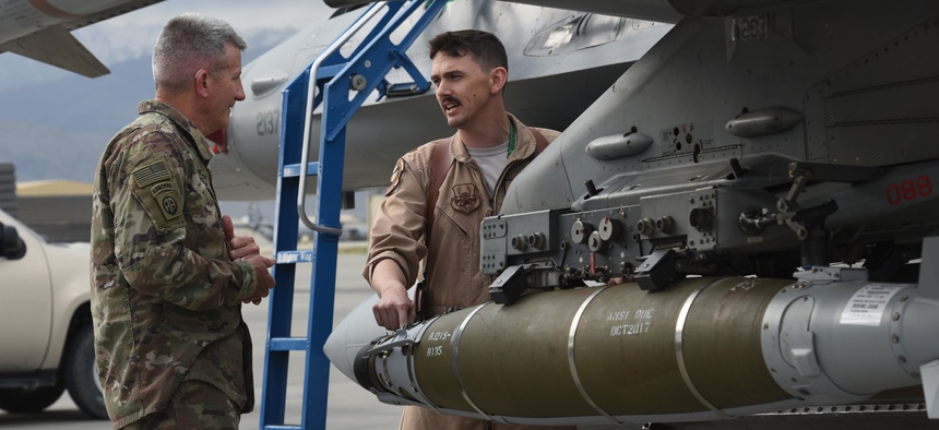 U.S. Army Gen. John Nicholson, commander of Resolute Support Mission and U.S. Forces Afghanistan, speaks with U.S. Air Force Maj. Greg Balzhiser, a F-16 Fighting Falcon pilot, at Bagram Airfield, Afghanistan, May 13, 2017.