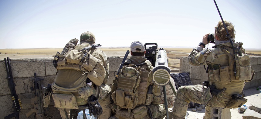 Belgian special forces soldiers sit on a rooftop with a guided-missile launcher, a few miles from the frontline, in the village of Abu Ghaddur, east of Tal Afar, Iraq, Sunday, Aug. 20, 2017.