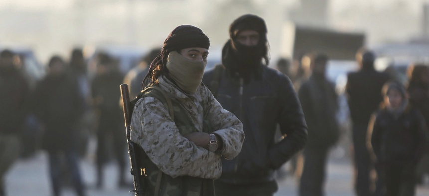 Armed Syrian fighters evacuated from the embattled Syrian city of Aleppo during the ceasefire arrive at a refugee camp in Rashidin, near Idlib, Syria, Tuesday, Dec. 20, 2016.