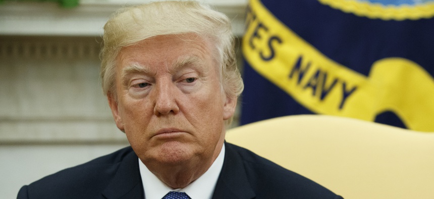 President Donald Trump listens as former Secretary of State Henry Kissinger speaks during a meeting in the Oval Office of the White House, Tuesday, Oct. 10, 2017, in Washington.