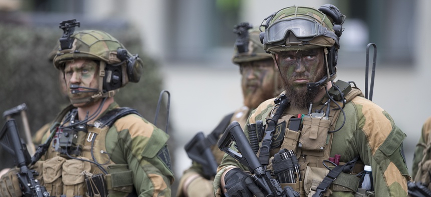 Norwegian soldiers of the NATO enhanced forward presence battalion attend a German President Frank-Walter Steinmeier welcome ceremony at the Rukla military base some 130 kms (80 miles) west of the capital Vilnius, Lithuania, Friday, Aug. 25, 2017.