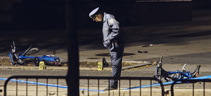 A police officer stands guard next to bicycles on a bike path at the crime scene after a motorist Tuesday drove onto the path, striking and killing several people, in Manhattan, Nov. 1.