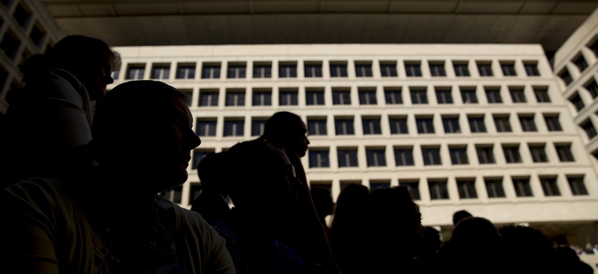 FBI employees listen as FBI Director Chris Wray speaks at his installation ceremony at the FBI Building earlier this fall. Wray has not publicly come to the agency's defense when Trump has criticized and delegitimized it.
