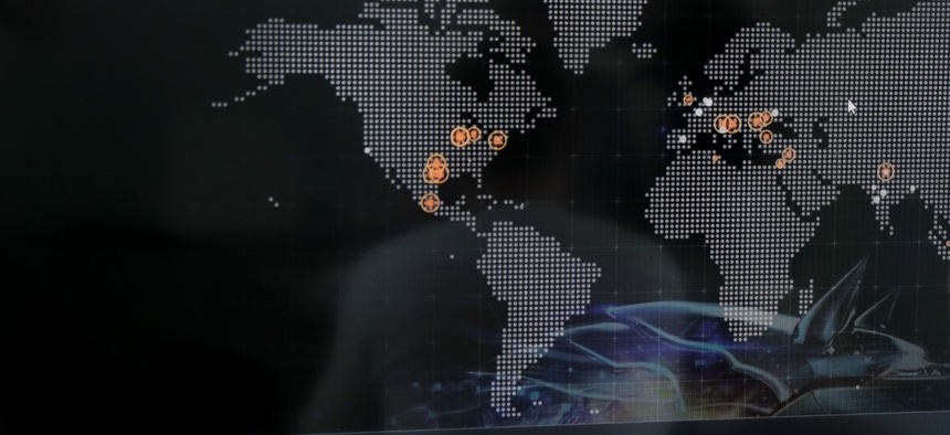 Bogdan Botezatu, a cyberthreats specialist with Bitdefender speaks during an interview with the Associated Press, backdropped by a real time cyber-attacks world map, at the headquarters of Bitdefender in Bucharest, Romania, Wednesday, June 28, 2017.