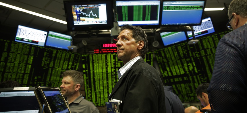 Traders work in a trading pit at the Chicago Board Options Exchange, Monday, Dec. 11, 2017, in Chicago, as they trade S&P 500 Options, unrelated to bitcoin futures. Trading in Bitcoin futures began Sunday on the CBOE.
