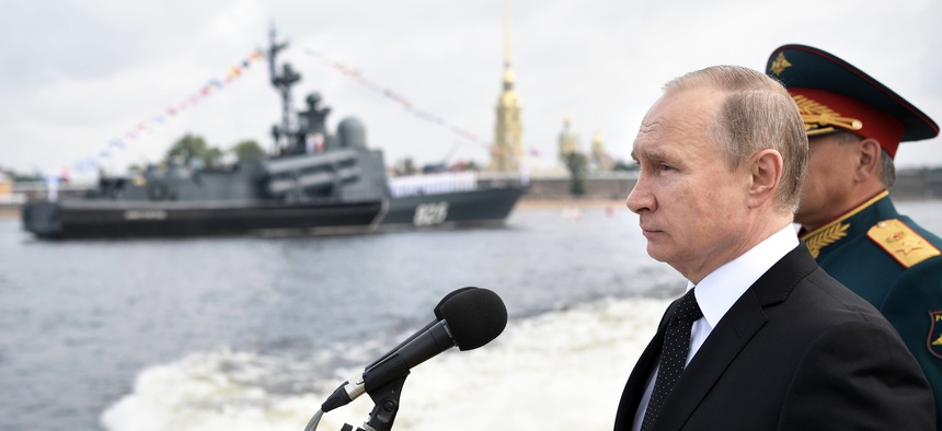 Russian President Vladimir Putin rides on a boat attending a naval parade during the Navy Day celebration this summer.