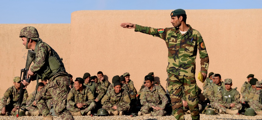 An Afghan National Army noncomissioned officer instructs his soldier to move during a clearance training drill at the Regional Military Training Center in Helmand Province, Afghanistan, March 8, 2017.