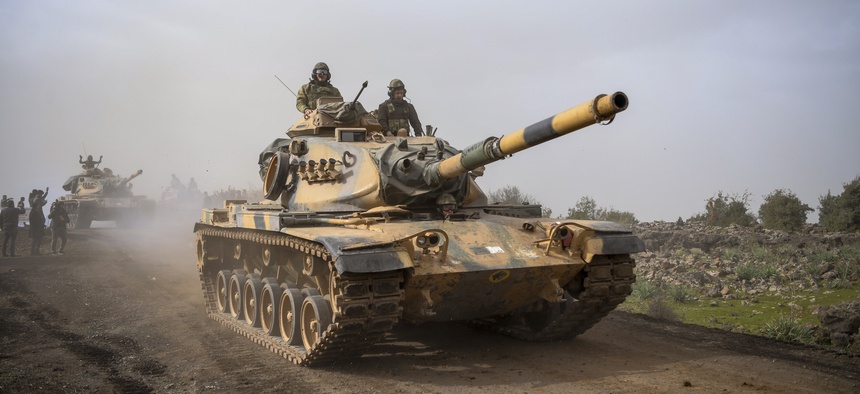 Turkish army tanks enter Afrin, an enclave in northern Syria controlled by U.S.-allied Kurdish fighters, in Hassa, Hatay, Turkey, Monday, Jan. 22, 2018.