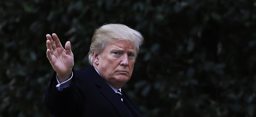 President Donald Trump waves as he walks towards the Oval Office upon arrival at the White House in Washington, Thursday, Feb. 1, 2018.