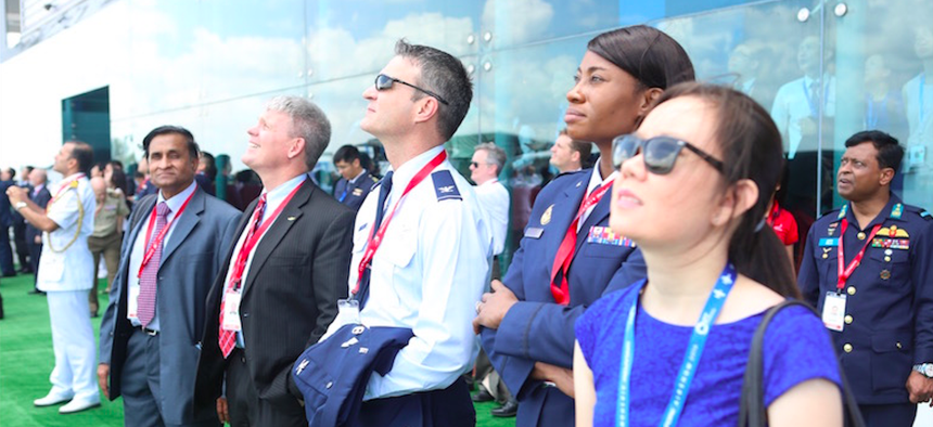 Attendees of the biennial regional event watch an air demonstration take place at the Singapore Airshow.