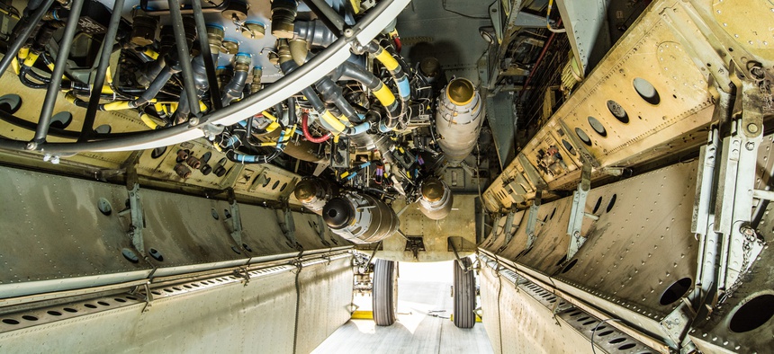 A U.S. B-52 Bomber sits on a flightline with munitions loaded on a newly installed conventional rotary launcher in its bomb bay, at Al Udeid Air Base, Qatar, Nov. 17, 2017.