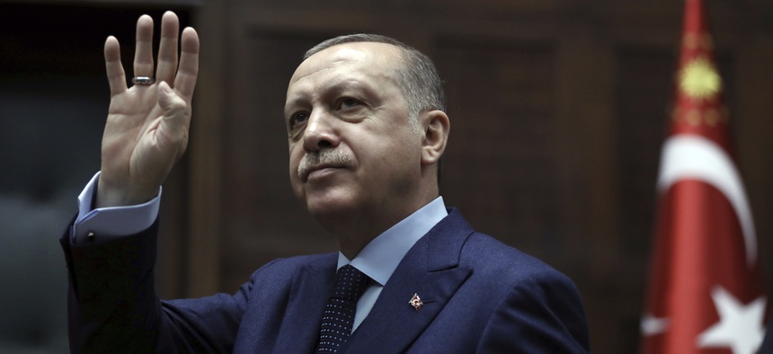 Turkey's President Recep Tayyip Erdogan waves to members of his ruling party at the parliament in Ankara, Turkey, Tues., Jan. 30, 2018.