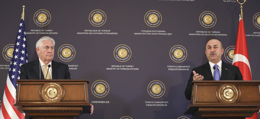 Turkey's Foreign Minister Mevlut Cavusoglu, right, talks as U.S. Secretary of State Rex Tillerson, left, listens during a joint news conference following their meeting in Ankara, Turkey, Friday, Feb. 16, 2018.