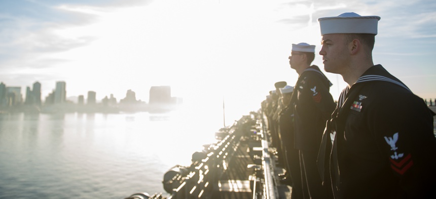 Sailors and Marines aboard the amphibious assault ship USS America (LHA 6) as it returns to its homeport of Naval Base San Diego, Feb. 2, 2018.