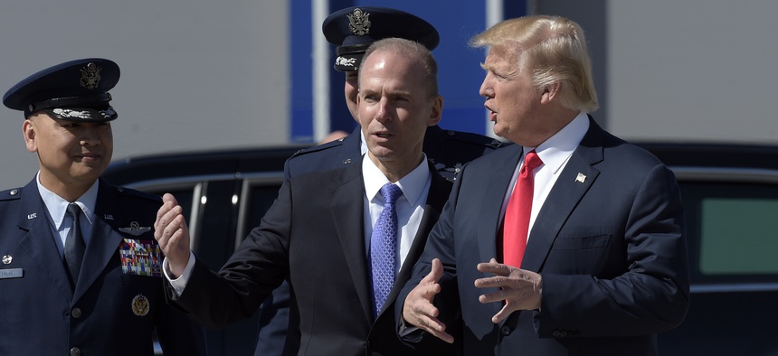 President Donald Trump talks with Boeing CEO Dennis Muilenburg upon his arrival on Air Force One at Charleston International Airport in North Charleston, S.C., in February 2017.