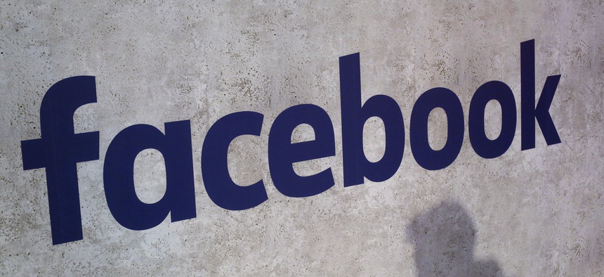 This Jan. 17, 2017, file photo shows a Facebook logo being displayed in a start-up companies gathering at Paris' Station F, in Paris.