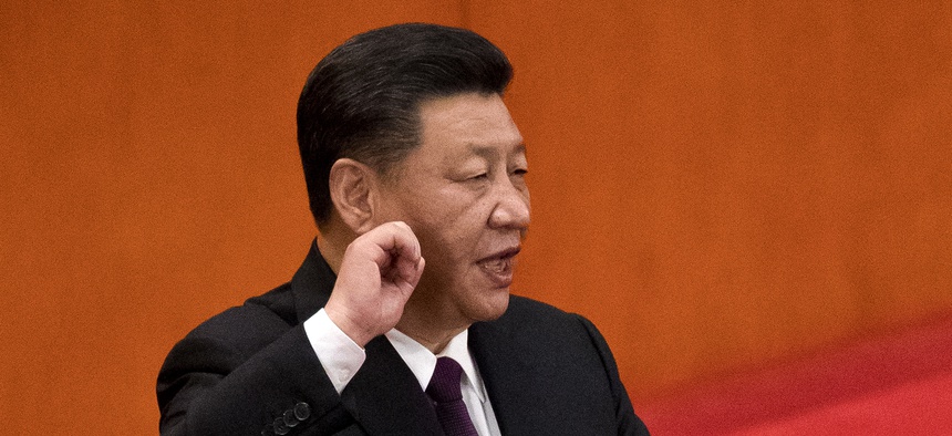 Chinese President Xi Jinping takes the oath of office after being formally re-elected to a second term as China's President during a plenary session of China's National People's Congress at the Great Hall of the People in Beijing, March 17, 2018