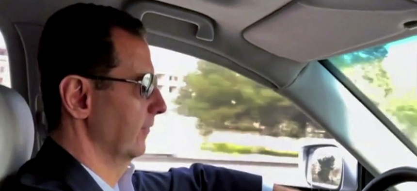 This frame grab from video released Sunday, March, 18, 2018 by the official Facebook page of the Syrian Presidency, shows Syrian President Bashar Assad driving himself to the newly captured areas of eastern Ghouta, near the capital Damascus, Syria.