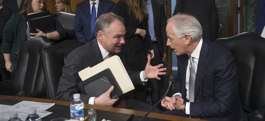 Senate Foreign Relations Committee Chairman Sen. Bob Corker, R-Tenn., right, confers with committee member Sen. Tim Kaine, D-Va. on Capitol Hill in Washington on Jan. 11, 2017.