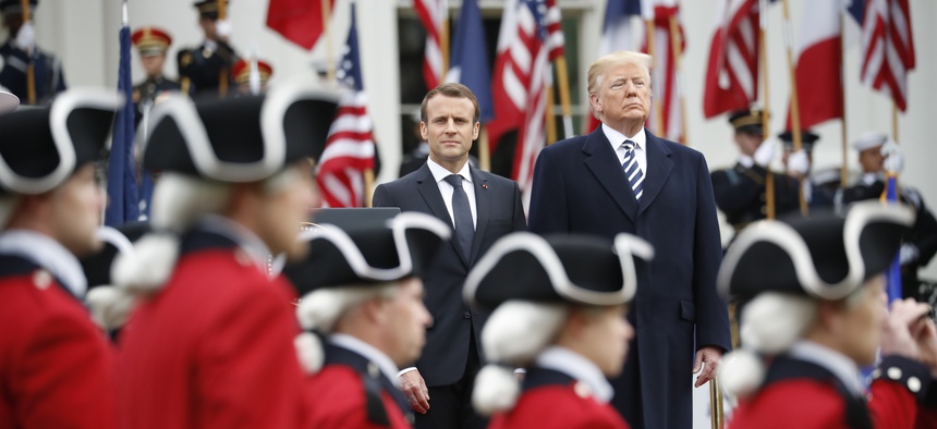 President Donald Trump and French President Emmanuel Macron stand during a State Arrival Ceremony on the South Lawn of the White House in Washington, Tuesday, April 24, 2018.