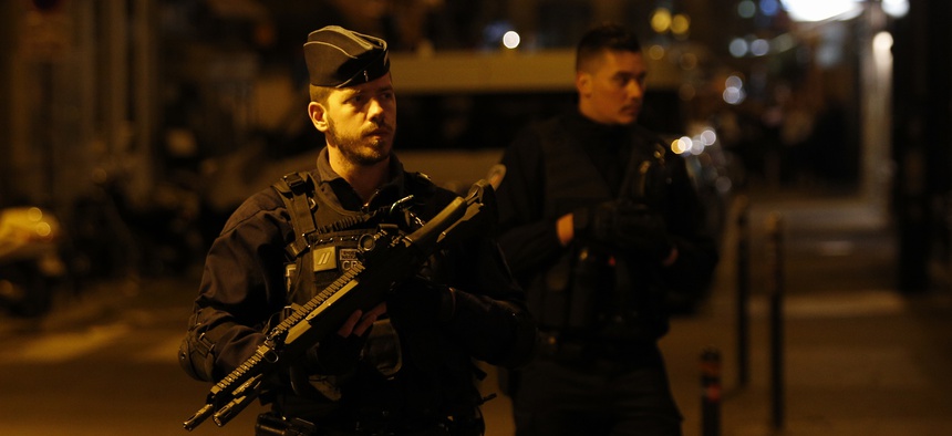 French police officers guard the site after a knife attack in central Paris, Saturday May 12, 2018. A knife-wielding assailant killed at least one person and injured four others in a lively neighborhood near Paris' famed Opera Garnier on Saturday.