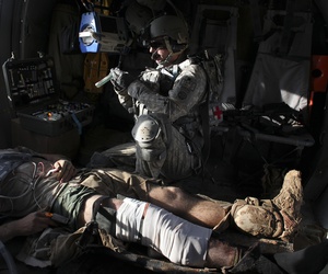 Airborne in a Black Hawk helicopter, U.S. Army flight medic Staff Sgt. Robert B. Cowdrey, of La Junta, Colo., with Charlie Company, All American Dustoff, attends to a U.S. Marine wounded in a rocket-propelled grenade attack, over Marjah, Helmand province, Airborne in a Black Hawk helicopter, U.S. Army flight medic Staff Sgt. Robert B. Cowdrey, of La Junta, Colo., with Charlie Company, All American Dustoff, attends to a U.S. Marine wounded in a rocket-propelled grenade attack, over Marjah, Helmand province,