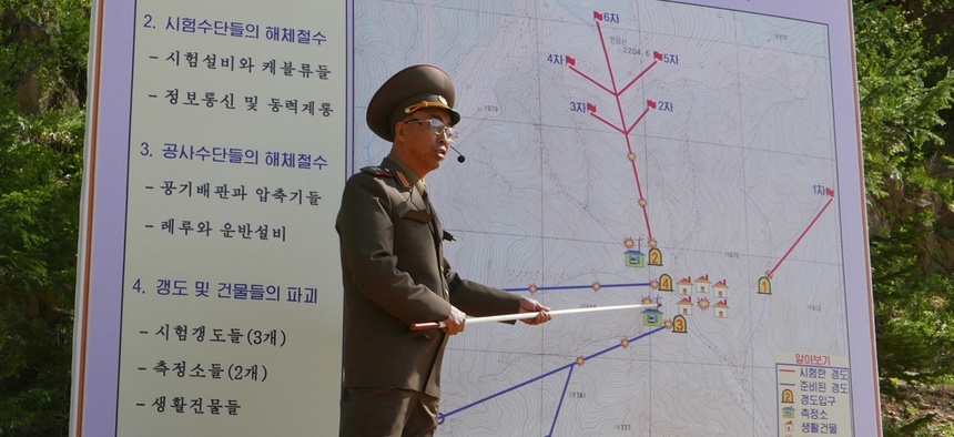 The Deputy Director of North Korea's Nuclear Weapons Institute, who would not give his name, briefs reporters about the dismantling of North Korea's nuclear test site, in Punggye-ri, North Hamgyong Province, North Korea, Thursday, May 24, 2018.