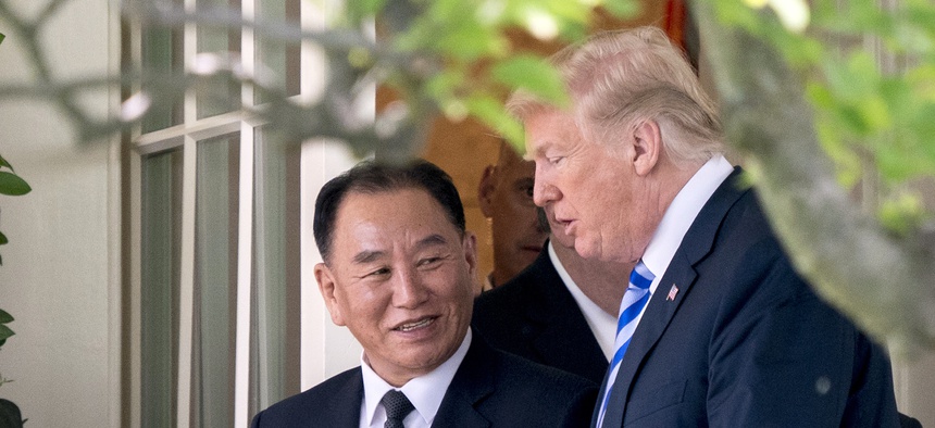 President Donald Trump talks with Kim Yong Chol, former North Korean military intelligence chief and one of leader Kim Jong Un's closest aides, as they walk from their meeting in the Oval Office of the White House in Washington, Friday, June 1, 2018.
