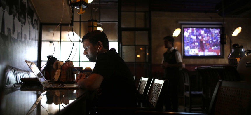 In this Aug. 30, 2016 photo, an Indian entrepreneur, left, works at Social Offline, a bar cum cafe with a lax co-working space, in New Delhi, India. As India emerges as one of the biggest markets in the world for tech-based startups.