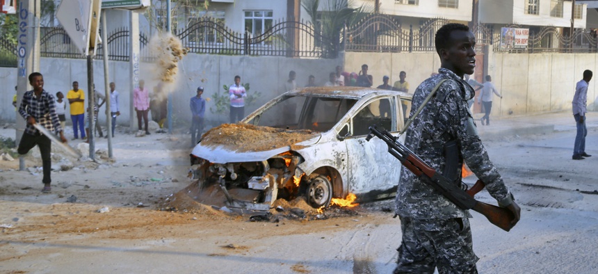 A Somali soldier attends the scene after a bomb attack near the office of the International Committee of the Red Cross in Mogadishu, Somalia Wednesday, March 28, 2018.