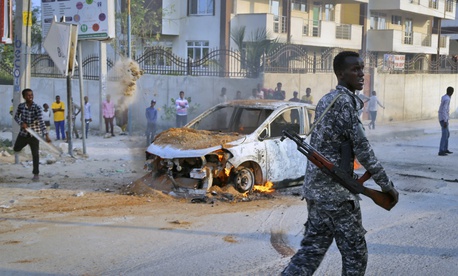 A Somali soldier attends the scene after a bomb attack near the office of the International Committee of the Red Cross in Mogadishu, Somalia Wednesday, March 28, 2018. A Somali soldier attends the scene after a bomb attack near the office of the International Committee of the Red Cross in Mogadishu, Somalia Wednesday, March 28, 2018.