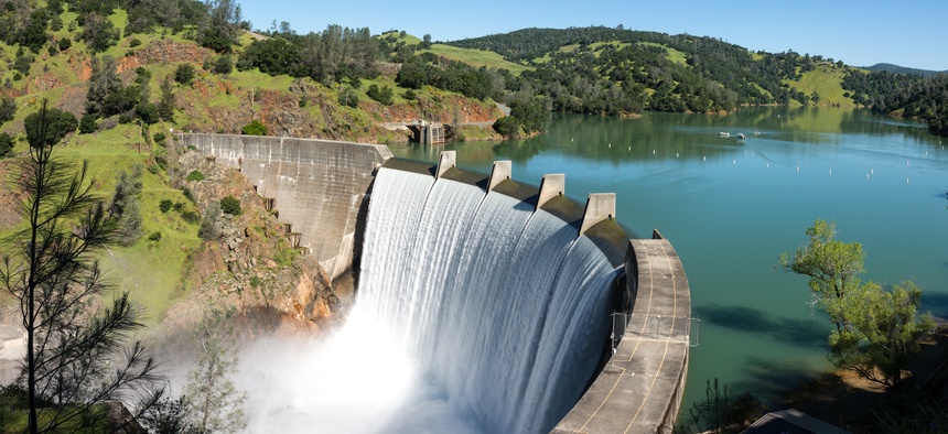 Water spills over the top of Englebright Dam on the Yuba River in California.